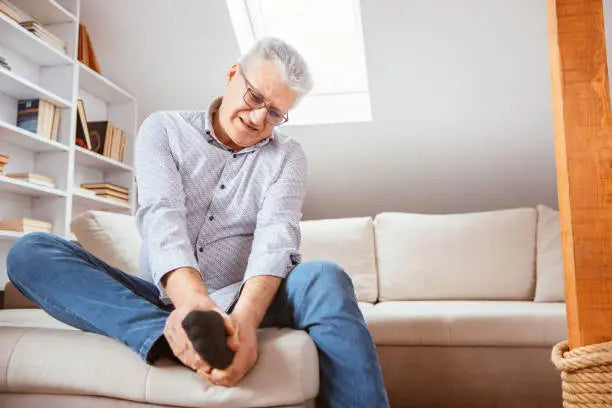 Man holding his foot in pain